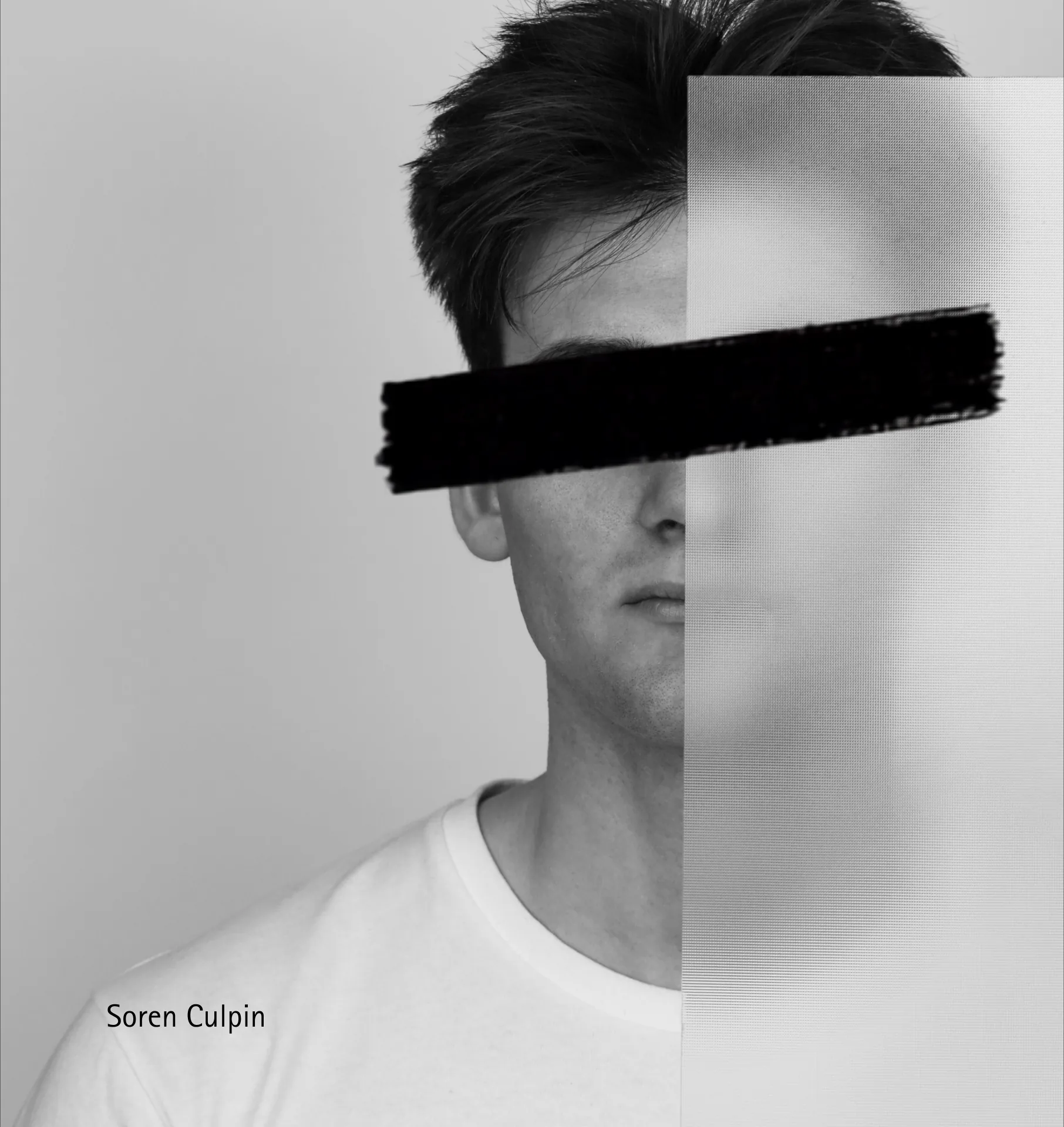 Soren Culpin holding a panel across the right side of his face, with a black bar obscuring his eyes